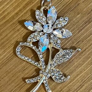 Crystal rhinestone flower bag tag/key chain on a gold tone chain 4 1/2”